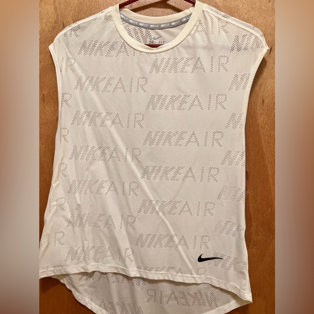 NIKE DRI FIT sleeveless high low top.
